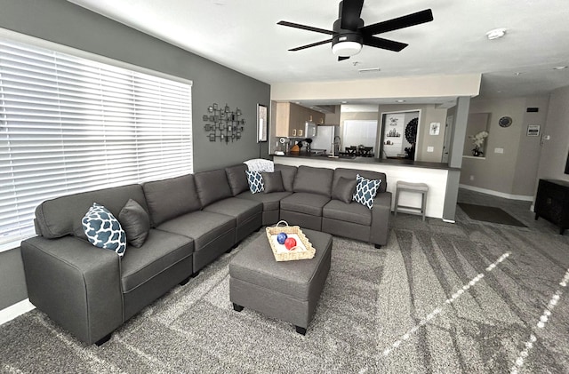 living room with ceiling fan and carpet floors