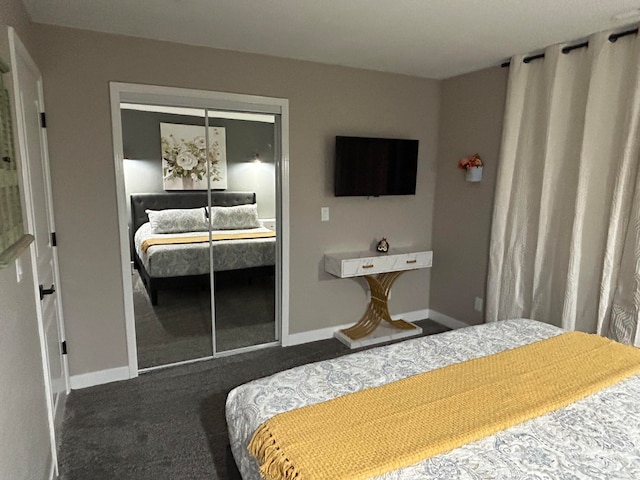 bedroom featuring dark colored carpet and a closet