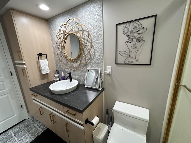 bathroom with tile patterned floors, vanity, and toilet