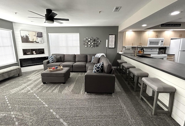 200 Meadow Ridge Ln Unit 6-2, Branson, MO 65616 - carpeted living room featuring recessed lighting, visible vents, ceiling fan, and a sink