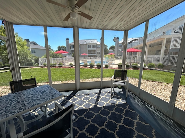 unfurnished sunroom with ceiling fan and wood ceiling