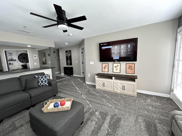 carpeted living room featuring ceiling fan