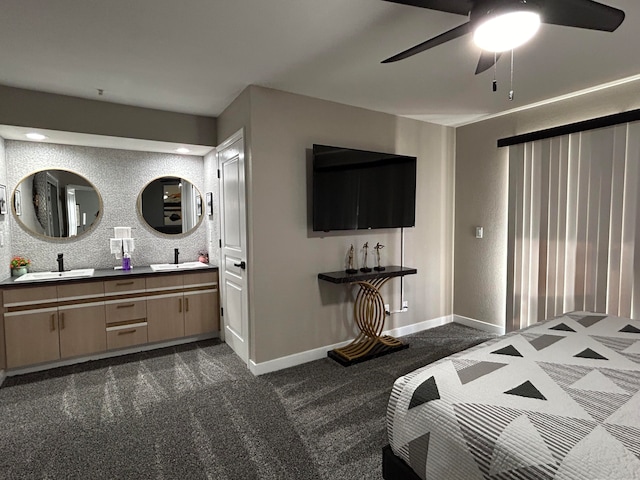 bedroom with dark carpet, sink, and ceiling fan