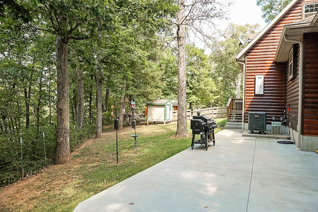 view of patio / terrace with a grill and a shed