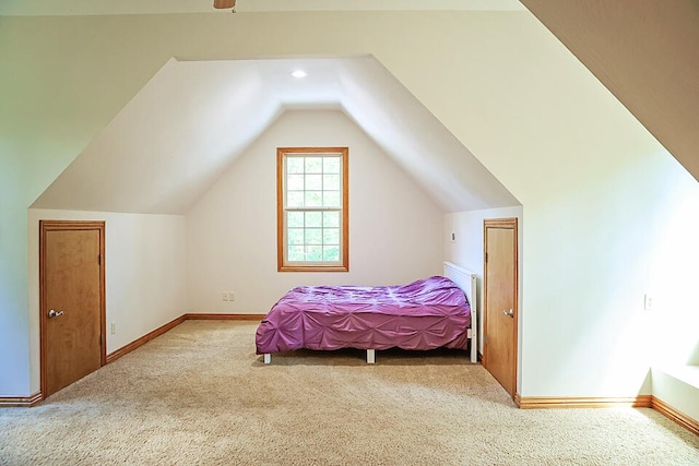 bedroom featuring vaulted ceiling and light colored carpet