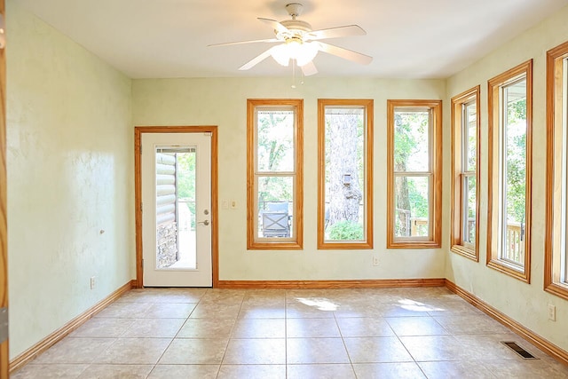 entryway with ceiling fan and light tile patterned floors