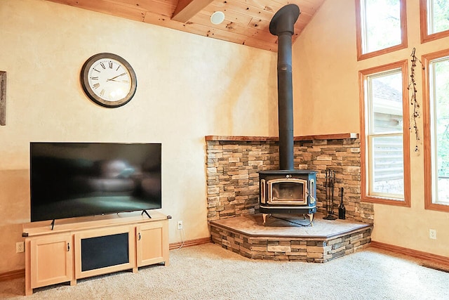 carpeted living room featuring wooden ceiling, high vaulted ceiling, beam ceiling, and a wood stove