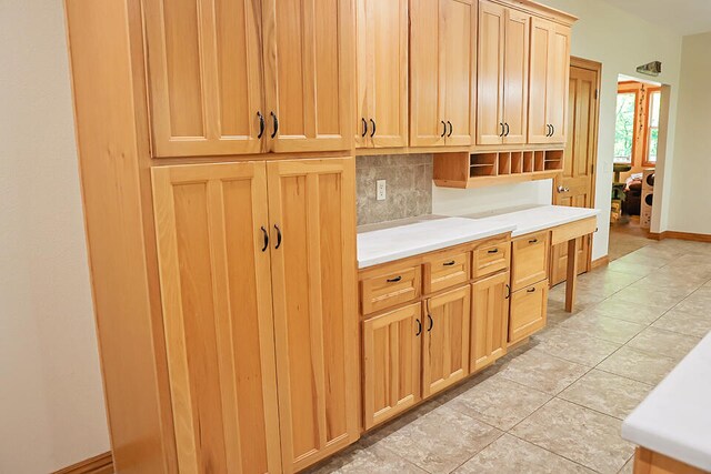 kitchen with backsplash and light tile patterned floors