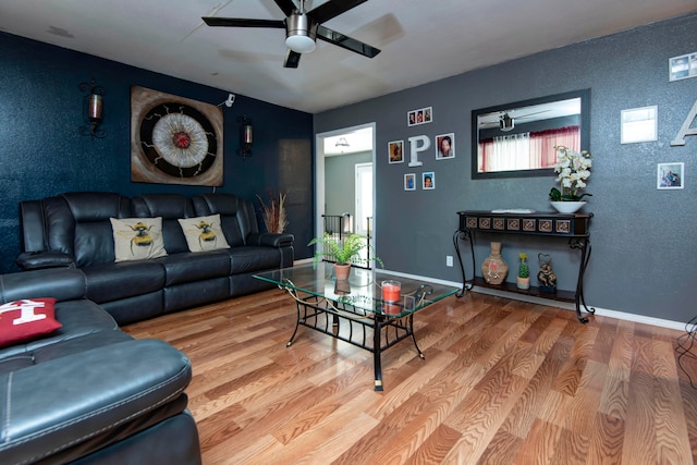 living room featuring ceiling fan and hardwood / wood-style flooring