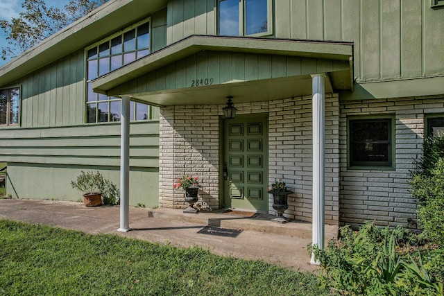 28409 Bali Rd, Warsaw, MO 65355 - view of exterior entry with board and batten siding and brick siding
