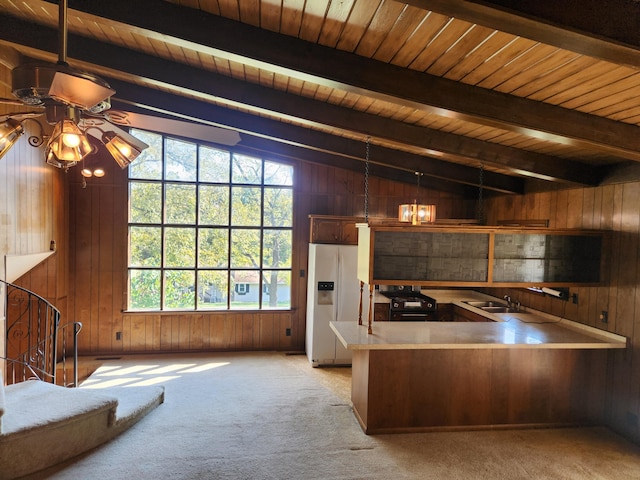 28409 Bali Rd, Warsaw, MO 65355 - kitchen featuring lofted ceiling with beams, light colored carpet, refrigerator with ice dispenser, a ceiling fan, and wooden walls