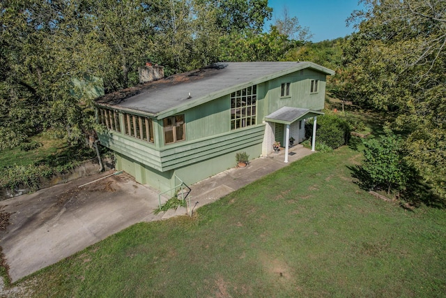 28409 Bali Rd, Warsaw, MO 65355 - exterior space featuring concrete driveway, a front lawn, and a chimney