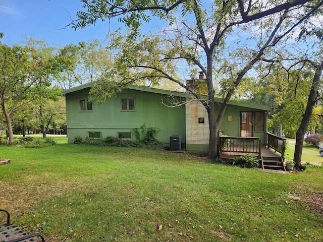 28409 Bali Rd, Warsaw, MO 65355 - back of house with a yard, a wooden deck, cooling unit, and a chimney
