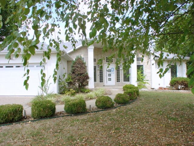 ranch-style house featuring a garage and french doors