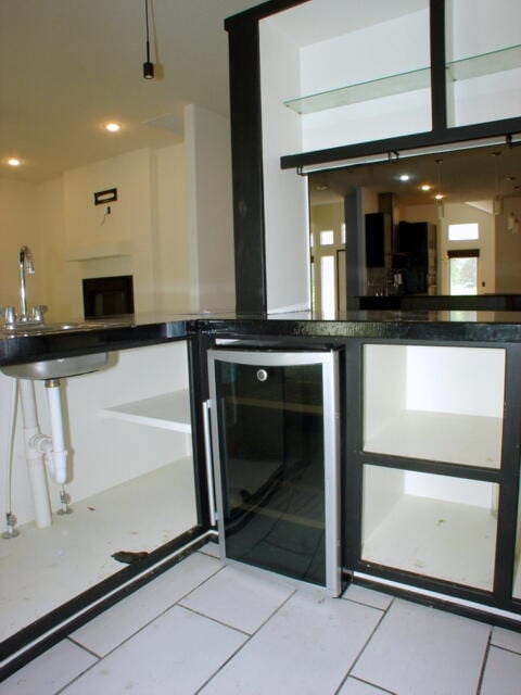 bar with beverage cooler and light tile patterned floors