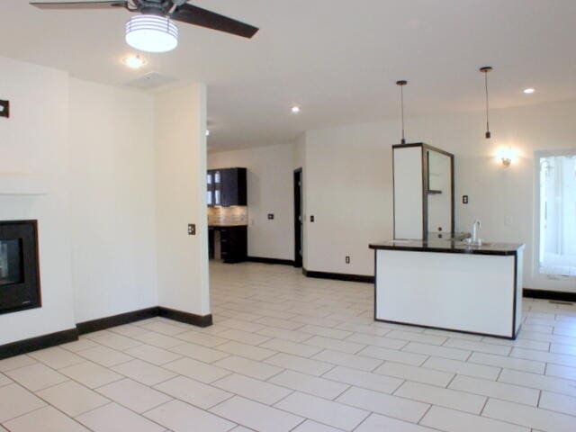 kitchen with ceiling fan, hanging light fixtures, and light tile patterned floors