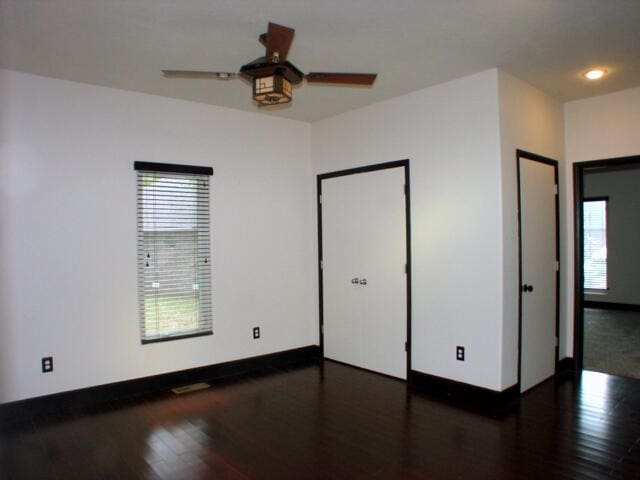 unfurnished room featuring dark hardwood / wood-style floors and ceiling fan