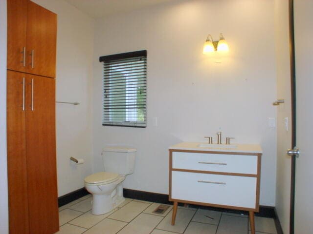 bathroom featuring vanity, toilet, and tile patterned floors