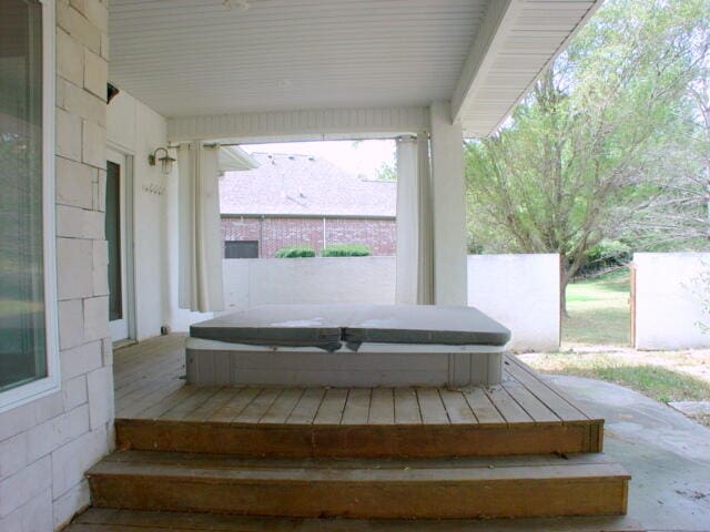 wooden deck featuring a covered hot tub