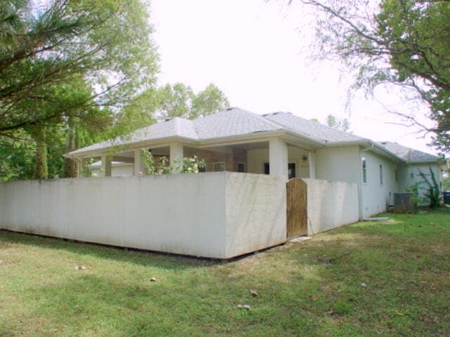 view of property exterior featuring a lawn