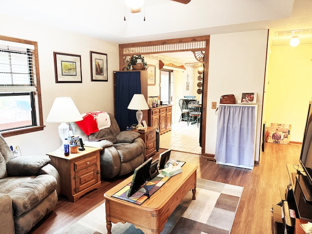 living room with ceiling fan and light hardwood / wood-style floors