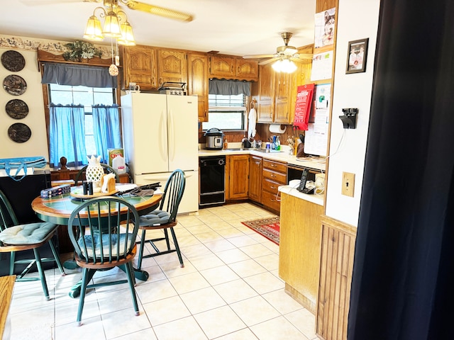 kitchen with black dishwasher, white refrigerator, stainless steel refrigerator, and a healthy amount of sunlight