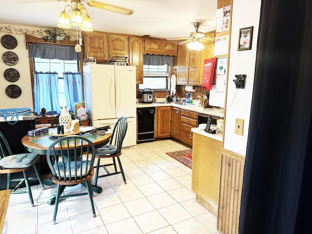 10520 County Road 237, Warsaw, MO 65355 - kitchen with brown cabinetry, black appliances, light tile patterned floors, ceiling fan, and light countertops