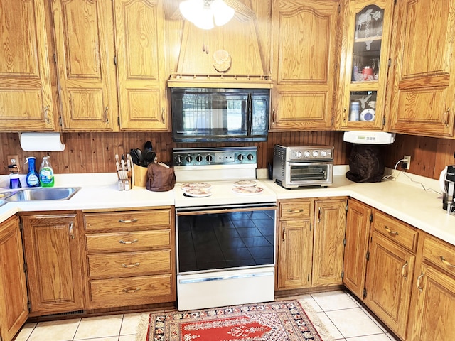 10520 County Road 237, Warsaw, MO 65355 - kitchen featuring white range with electric cooktop, black microwave, light tile patterned floors, a toaster, and light countertops