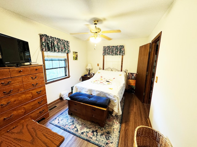 bedroom featuring ceiling fan and dark hardwood / wood-style floors