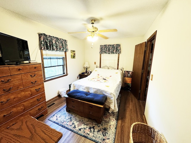 10520 County Road 237, Warsaw, MO 65355 - bedroom with dark wood finished floors, a ceiling fan, and visible vents