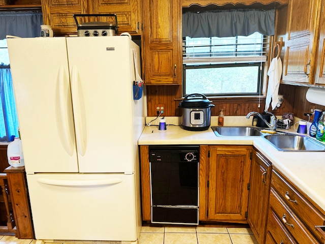 kitchen featuring light tile patterned flooring, white refrigerator, and dishwasher