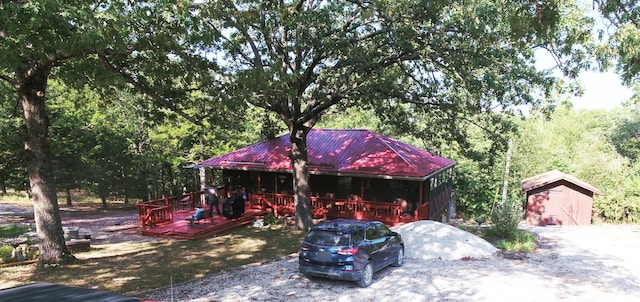 exterior space featuring a deck and a storage shed