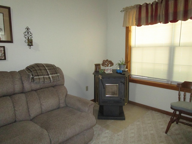 living room with light colored carpet, a wood stove, and a healthy amount of sunlight