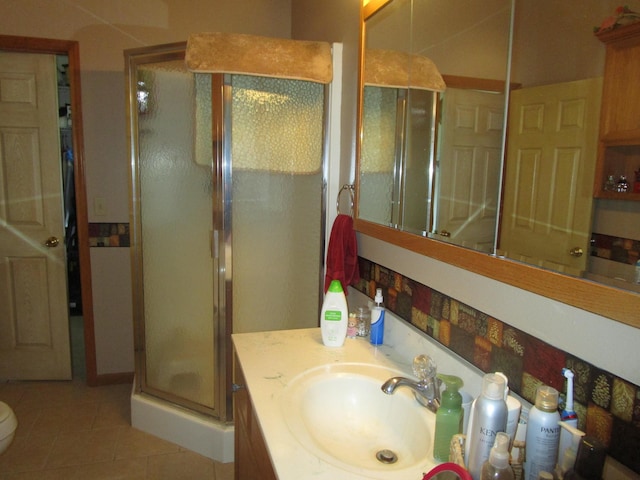 full bathroom featuring tile patterned floors, vanity, a shower stall, and toilet