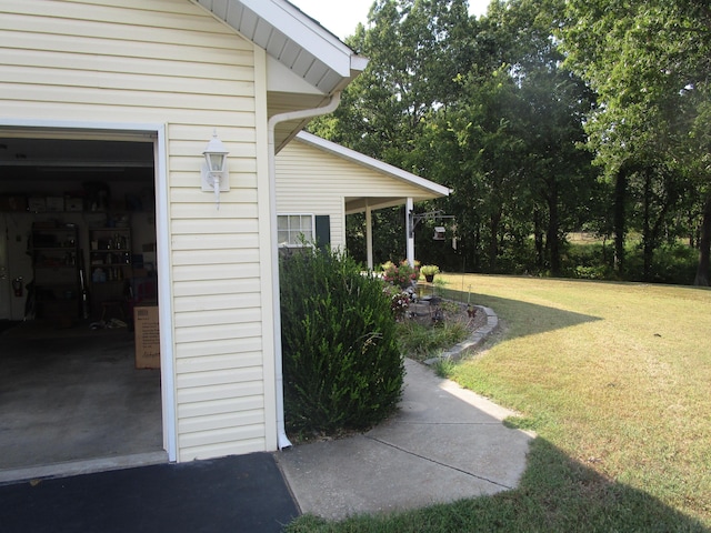 view of side of home with a garage and a lawn