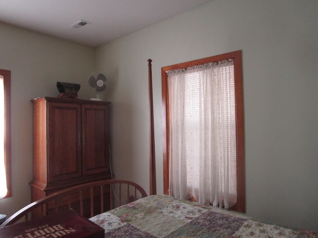 bedroom featuring visible vents and multiple windows