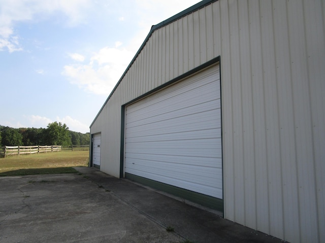 detached garage featuring fence