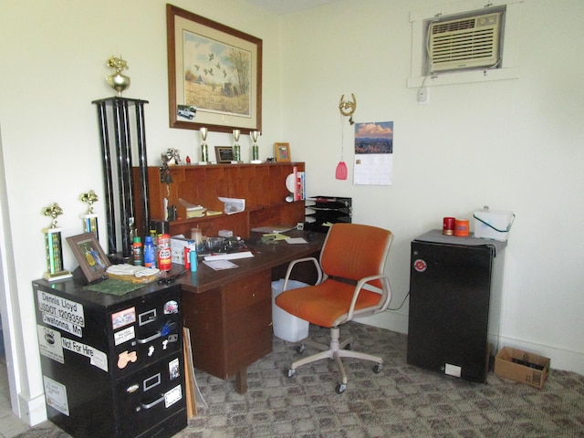 office area with a wall mounted air conditioner and carpet flooring