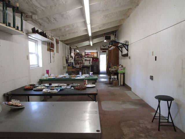 kitchen featuring lofted ceiling with beams, concrete floors, and visible vents