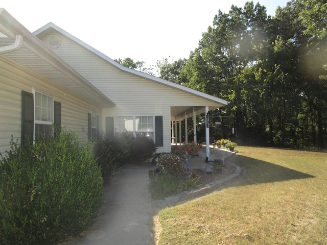 view of side of property with a lawn and a patio