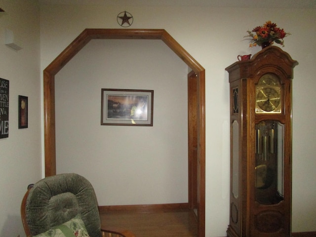 hallway with wood finished floors and baseboards