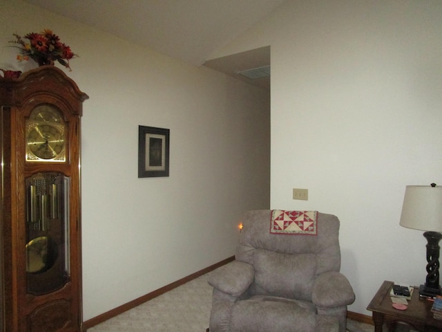 sitting room featuring baseboards, vaulted ceiling, and carpet flooring