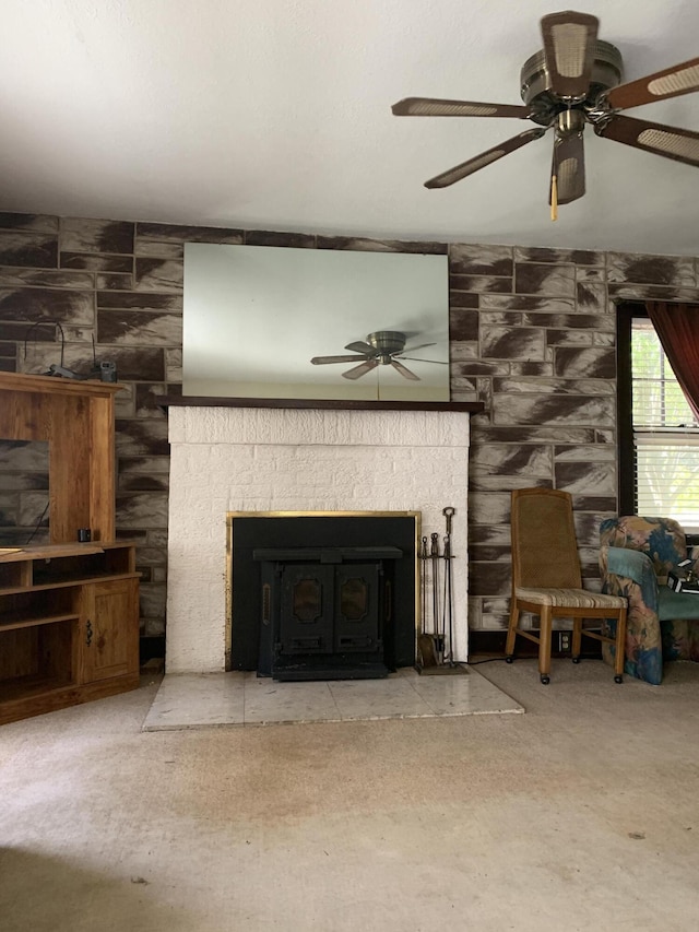living area with a fireplace and ceiling fan
