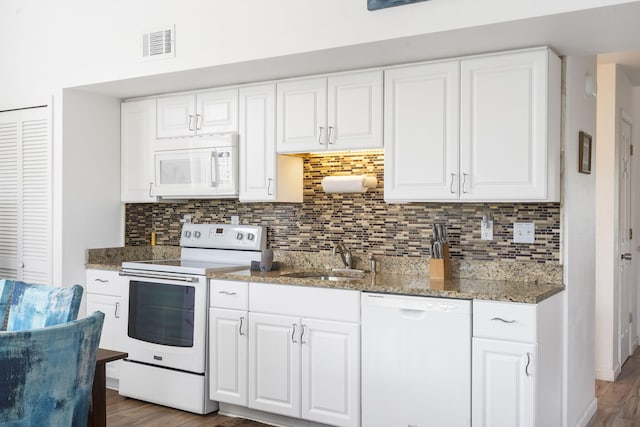 kitchen with white appliances, white cabinets, sink, and dark hardwood / wood-style flooring