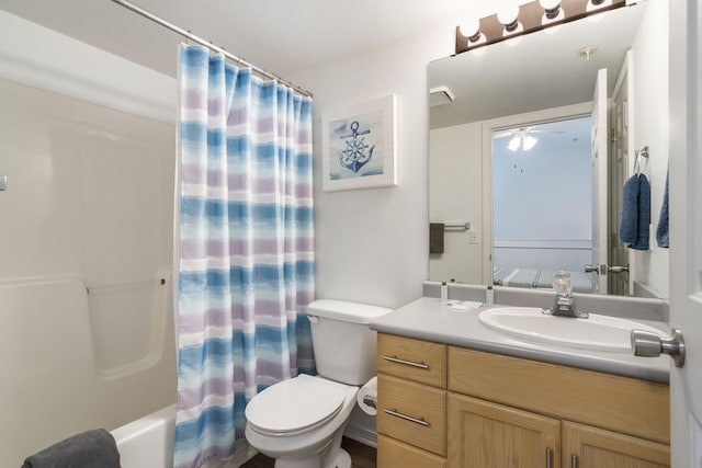 full bathroom featuring shower / tub combo with curtain, ceiling fan, vanity, and toilet