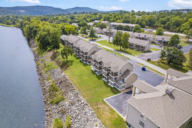 drone / aerial view featuring a water and mountain view