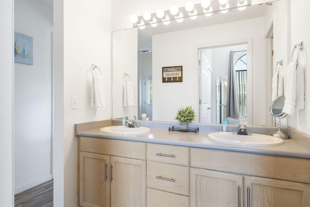 bathroom with hardwood / wood-style flooring and vanity