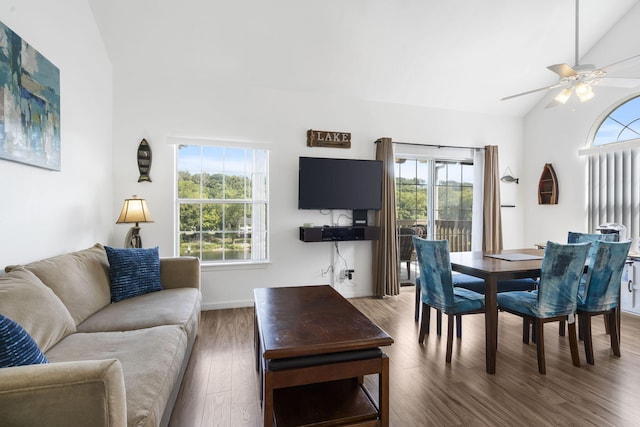 living room with ceiling fan, lofted ceiling, dark hardwood / wood-style floors, and a wealth of natural light