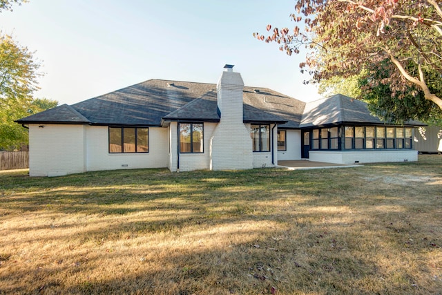 rear view of house with a lawn