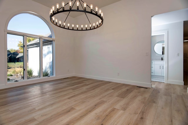 unfurnished dining area with light hardwood / wood-style flooring and an inviting chandelier